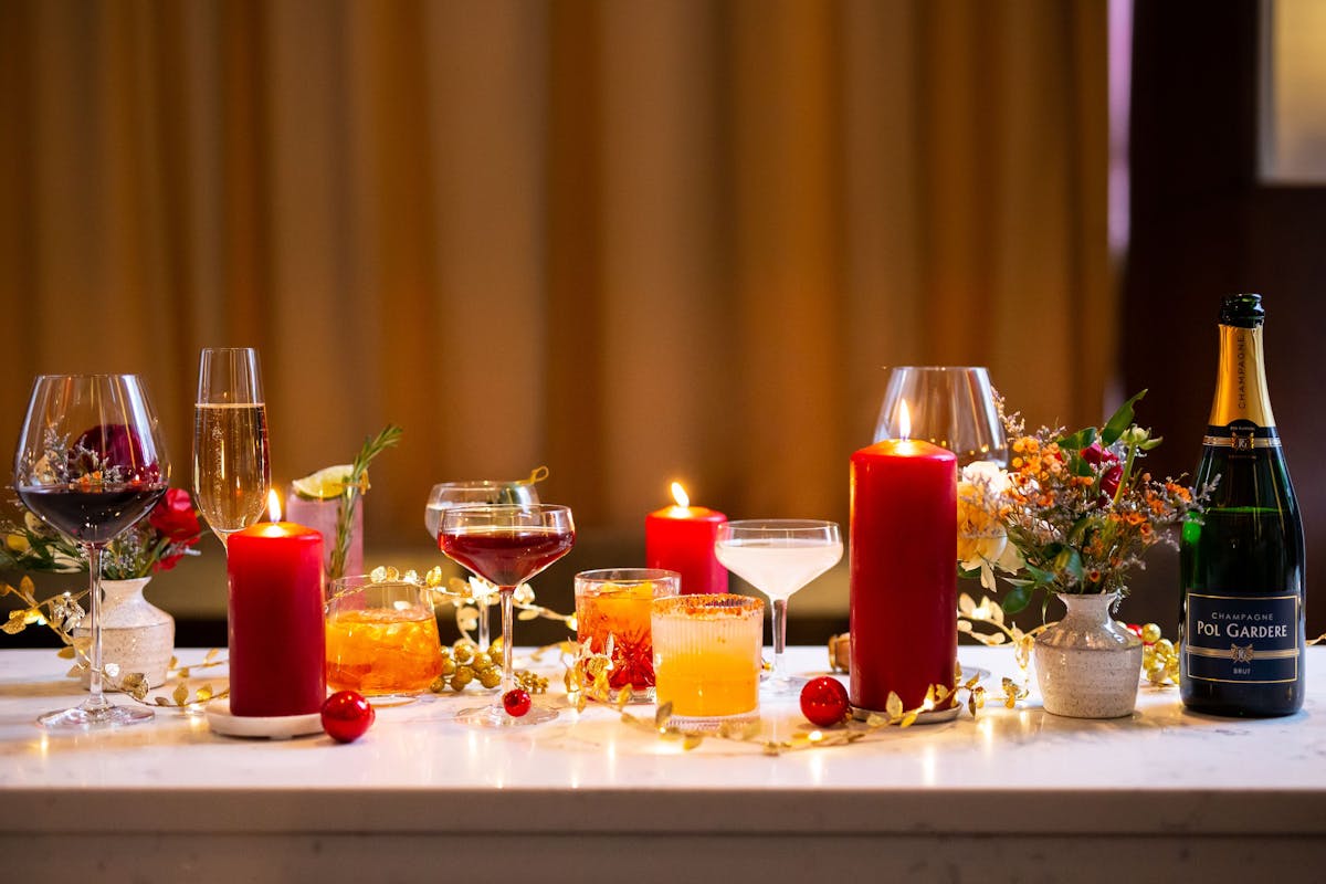 a bottle of wine glasses sitting on a table