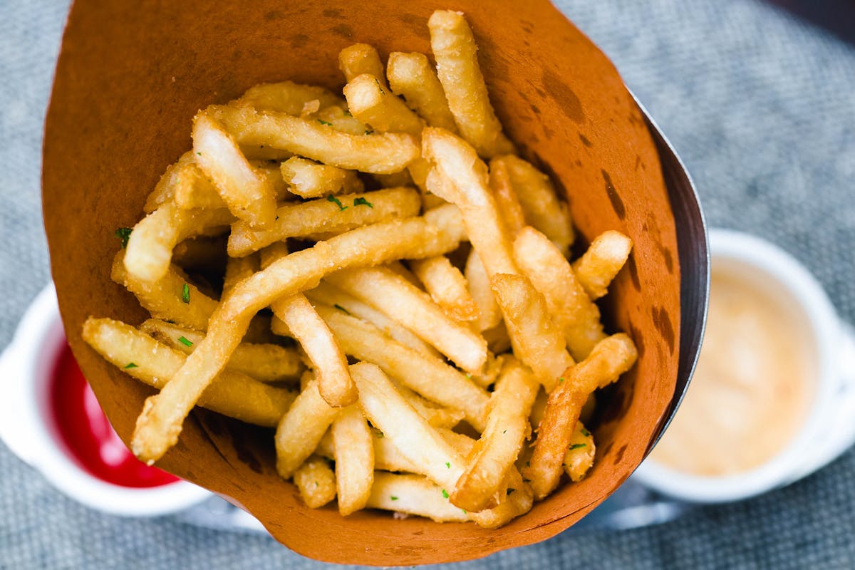 a close up of a plate of hot dogs and french fries