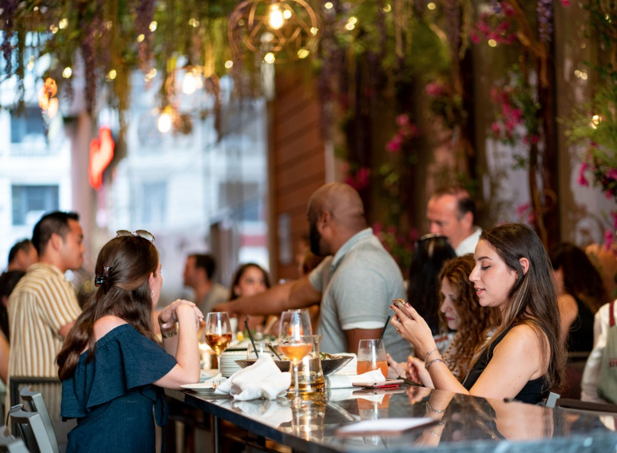 a group of people sitting at a table with wine glasses