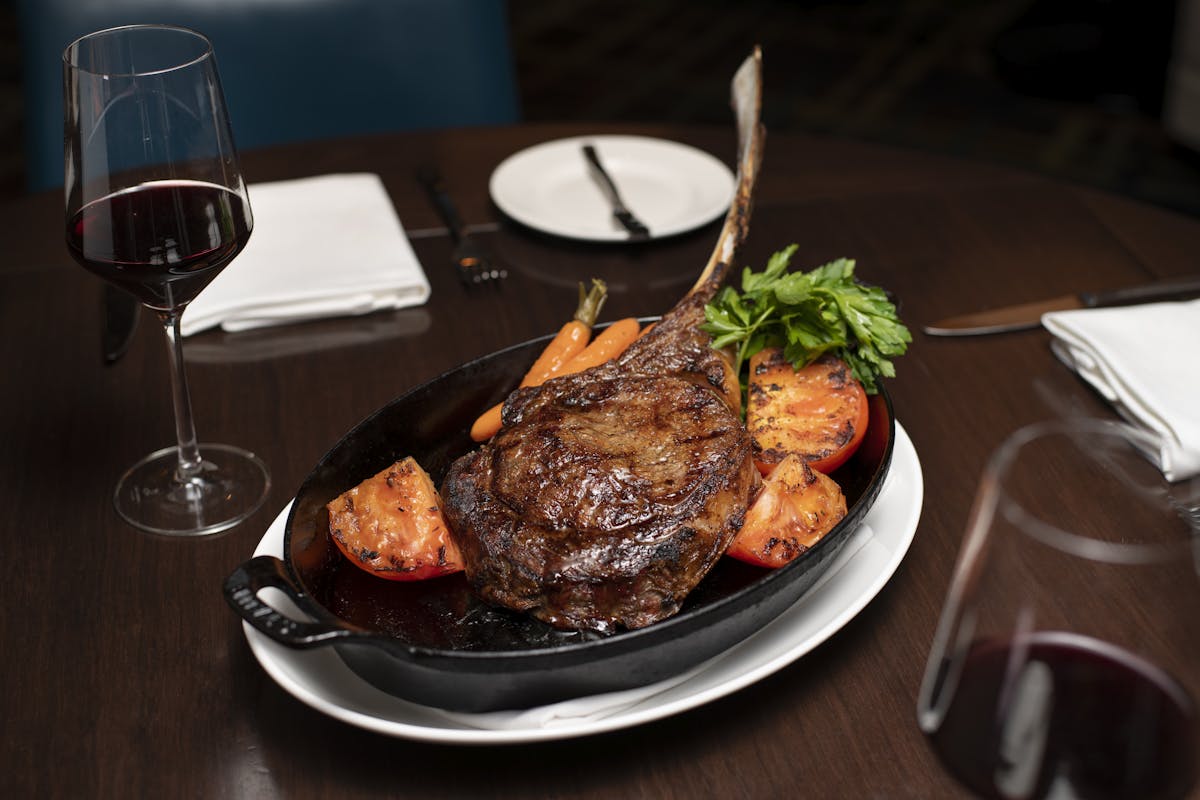 a plate of food and a glass of wine