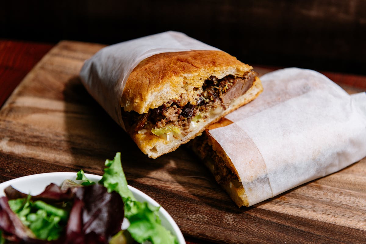 a sandwich sitting on top of a wooden table