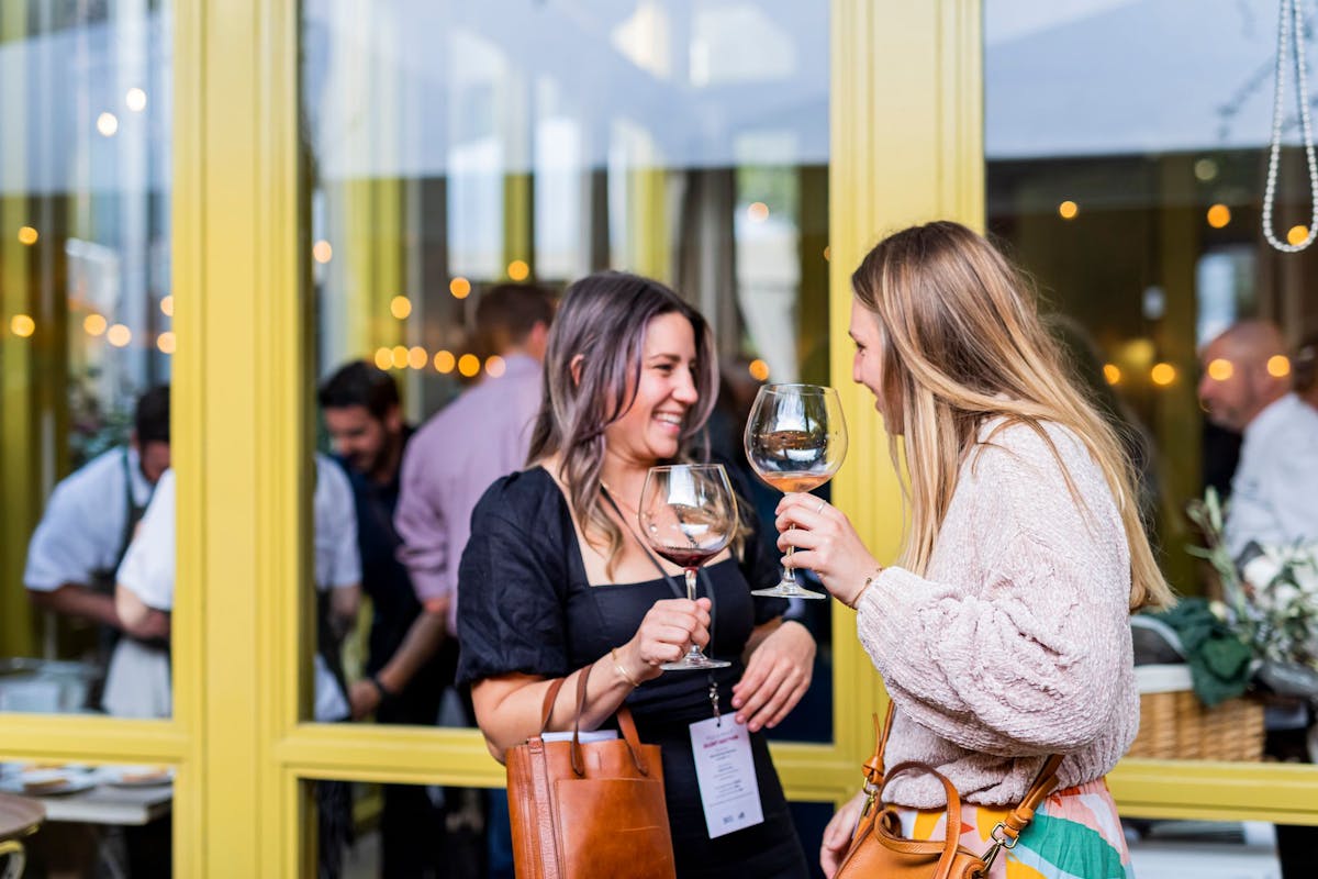 a woman drinking a glass of wine