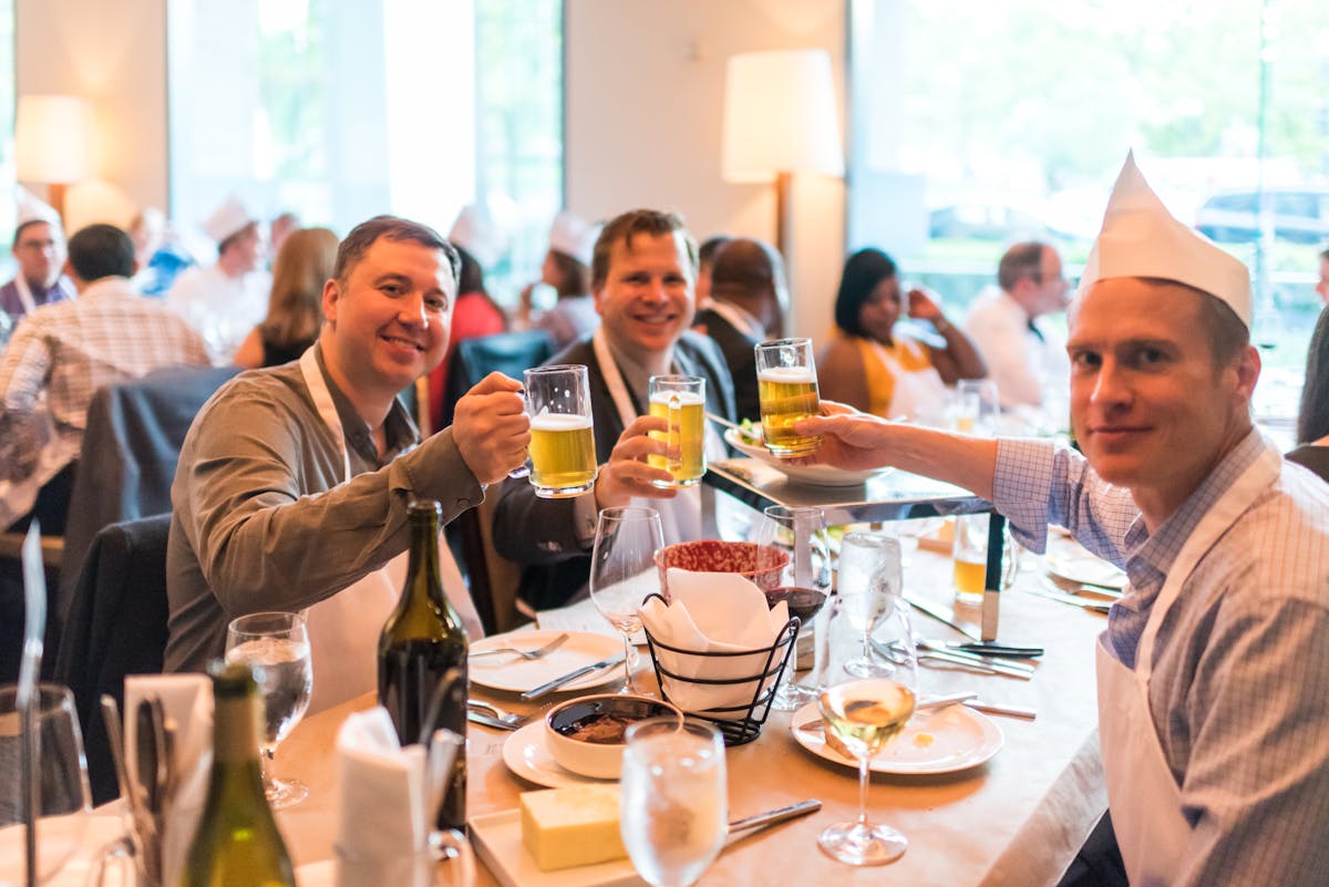 a group of people sitting at a table with wine glasses