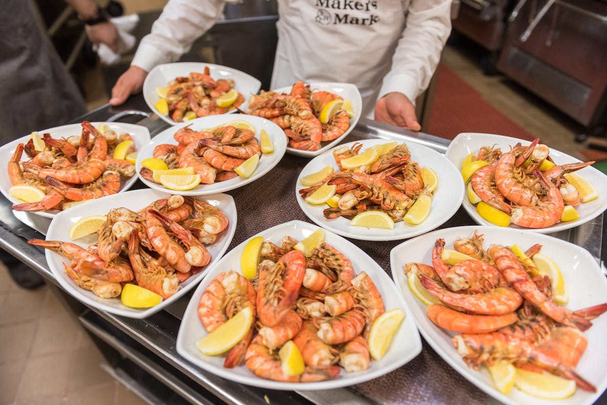 a group of people sitting at a table with a plate of food