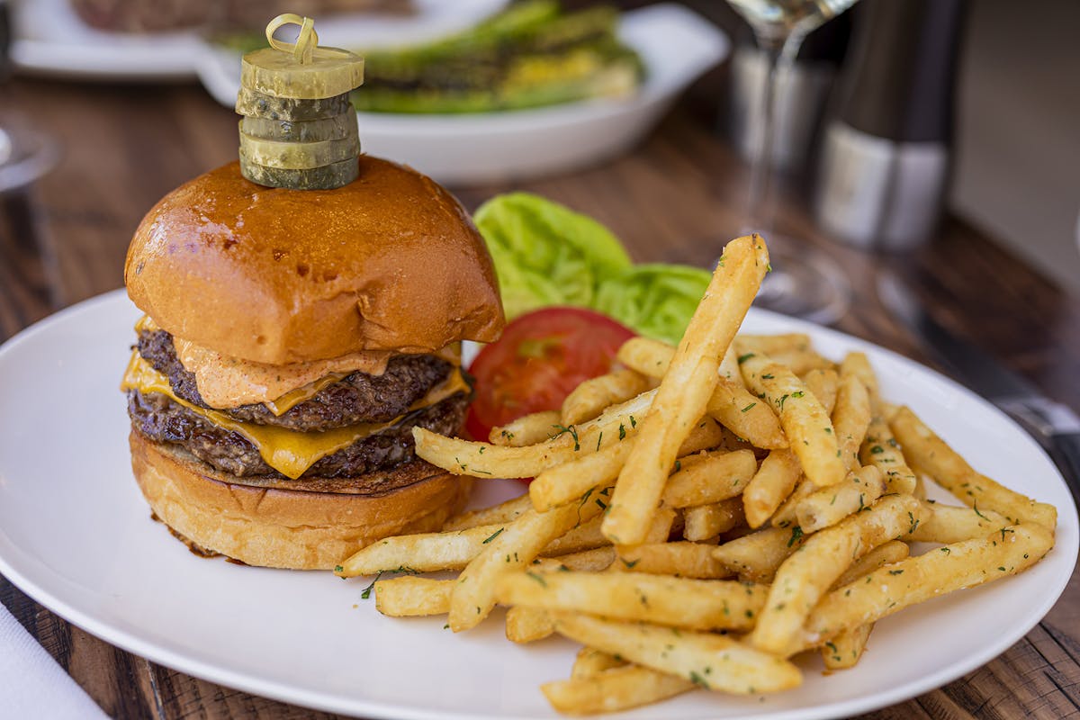 a table topped with a sandwich and fries on a plate