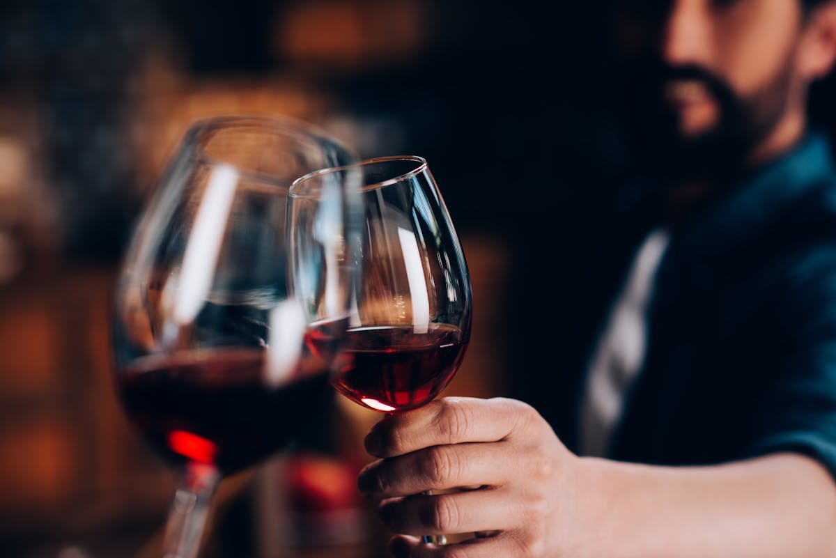 a hand holding a glass of wine