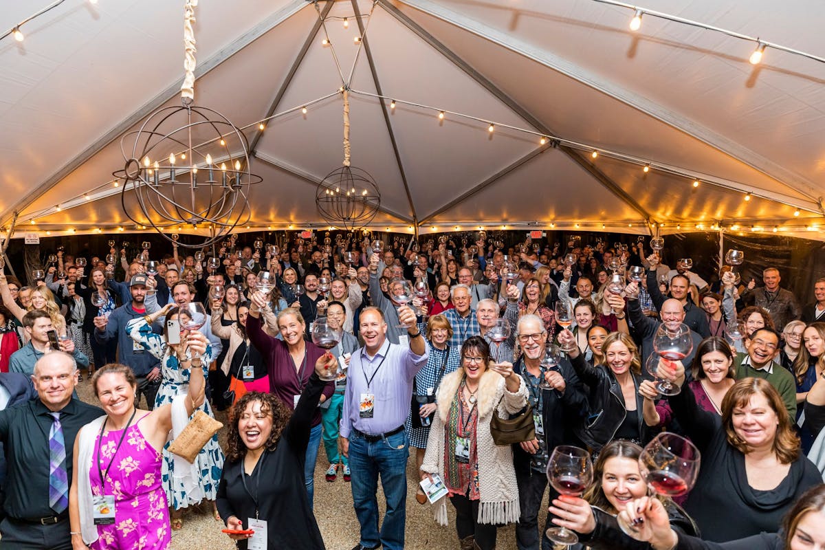 a group of people standing in front of a crowd posing for the camera