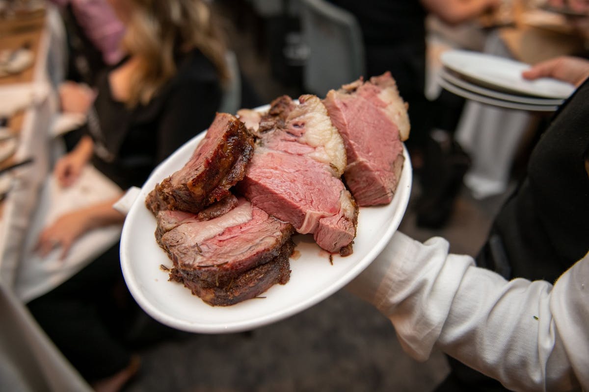 a person sitting at a table with a plate of food