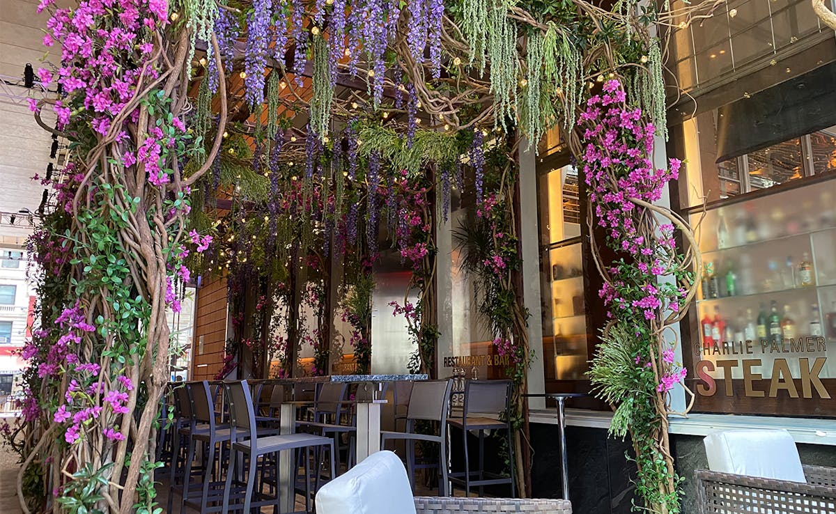 a vase of flowers sits in front of a building