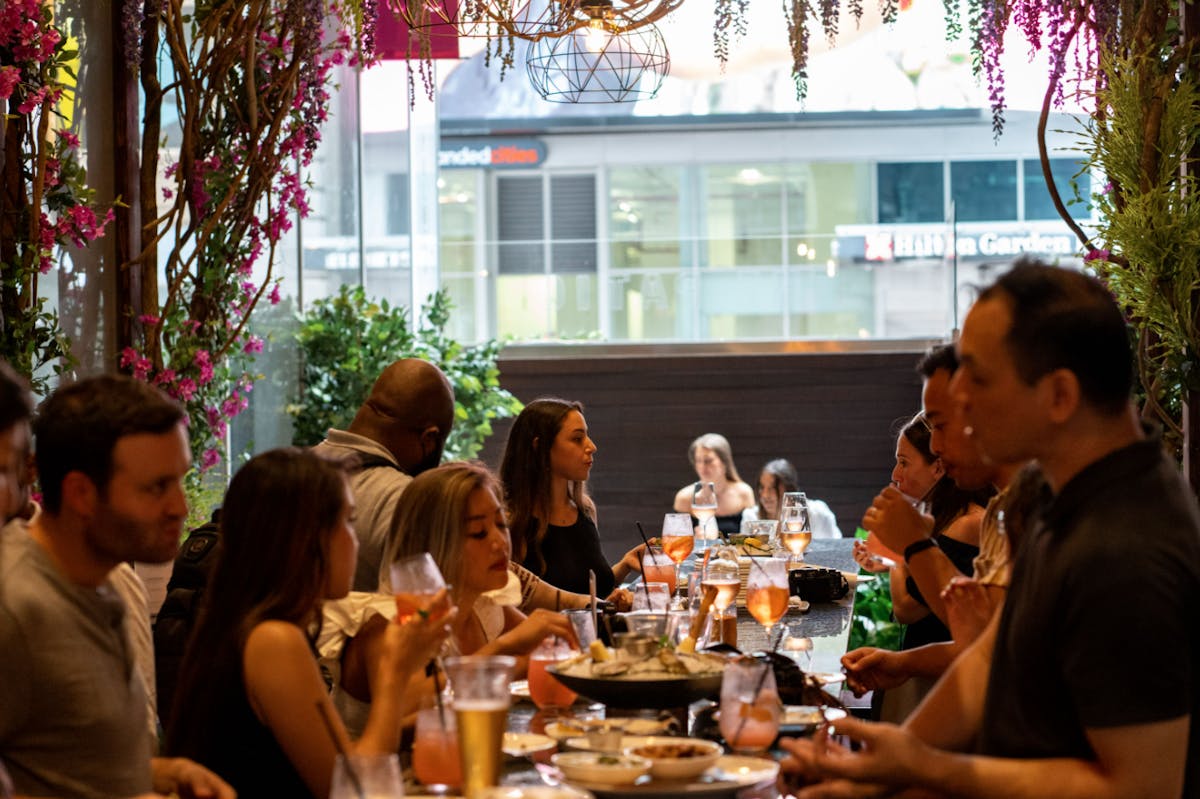 a group of people sitting at a table in a restaurant