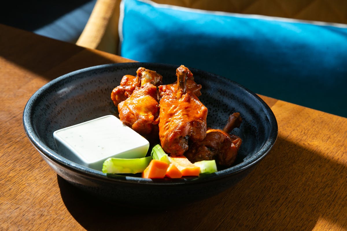 a bowl of food sitting on top of a wooden table