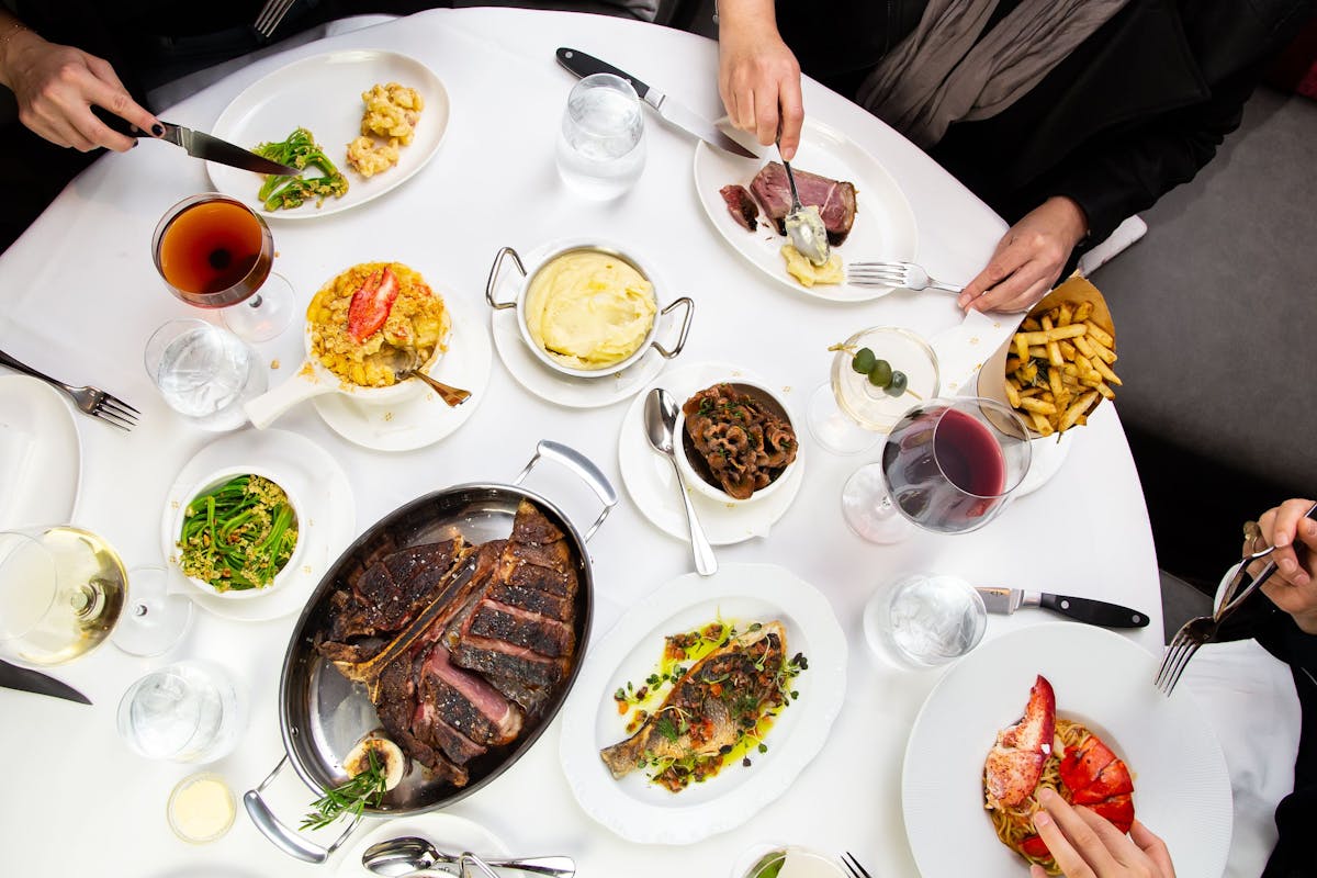 a group of people sitting at a table with a plate of food