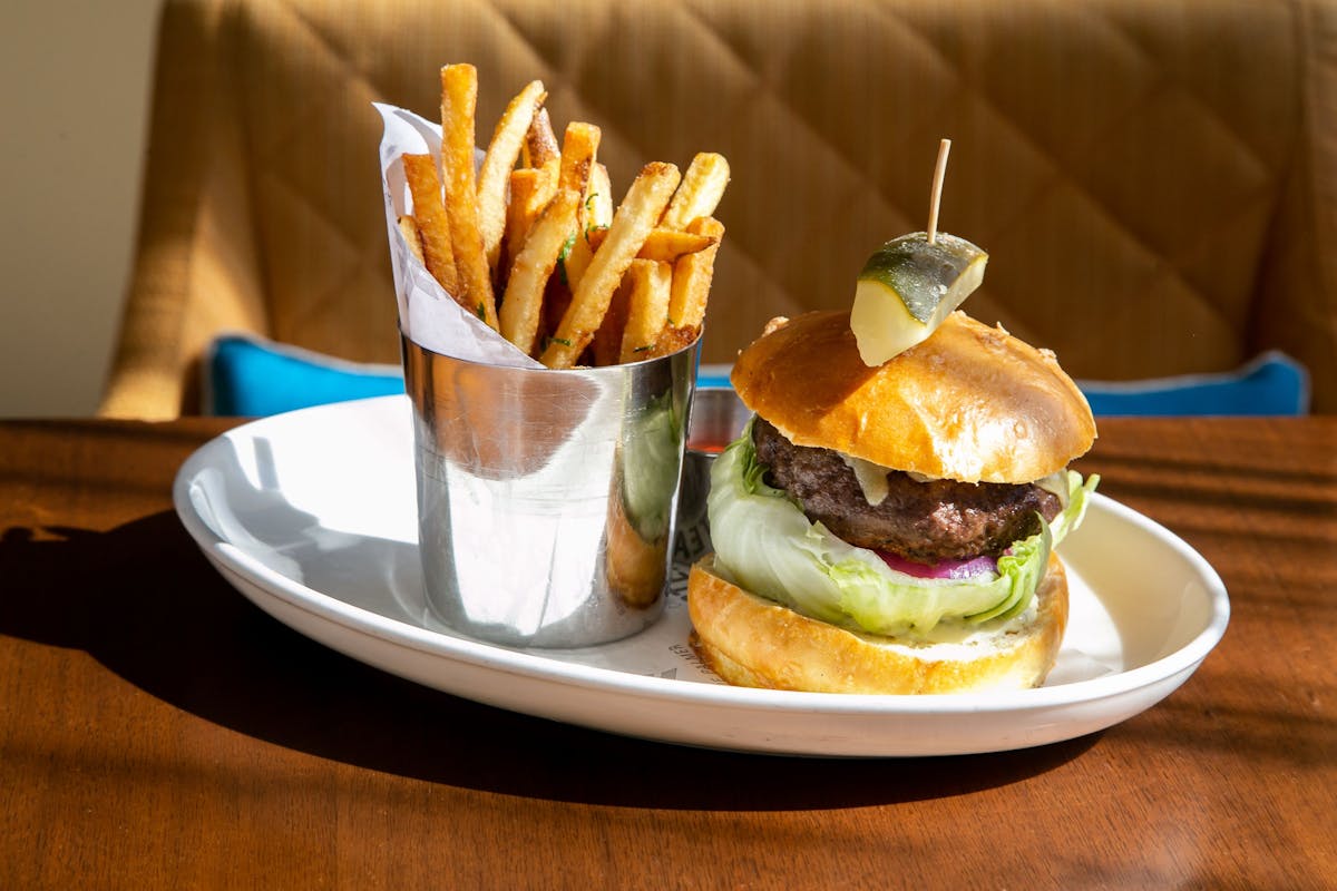 a sandwich sitting on top of a plate of food on a table