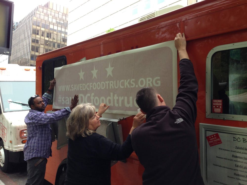 a group of people standing in front of a bus