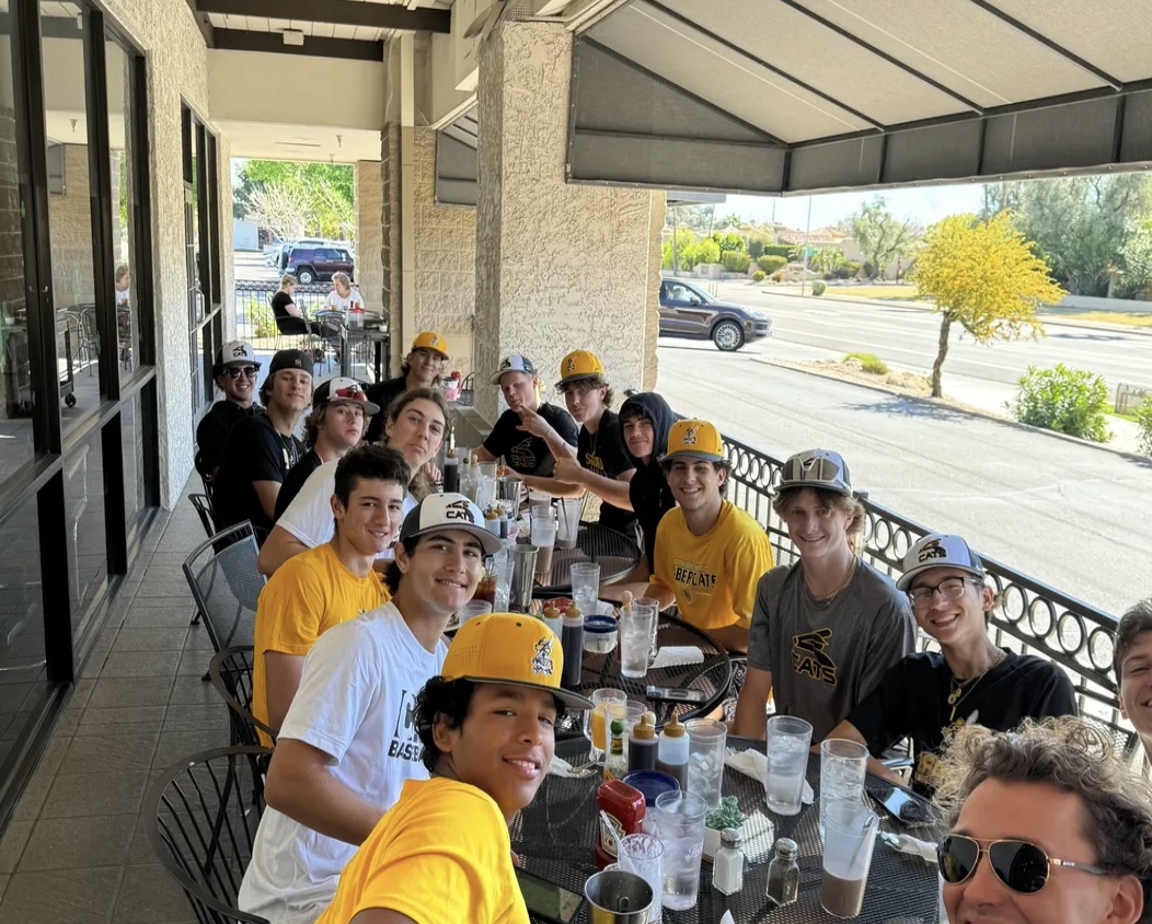 a group of people sitting at a table in a restaurant