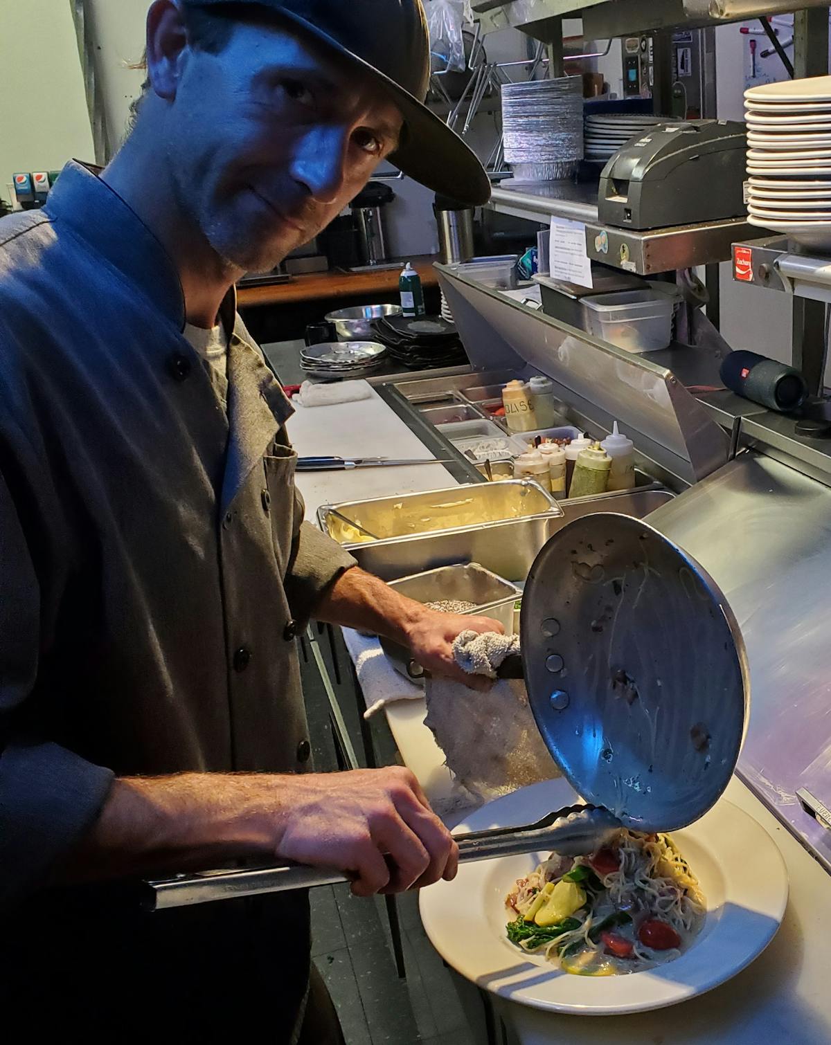 a man cooking in a kitchen preparing food