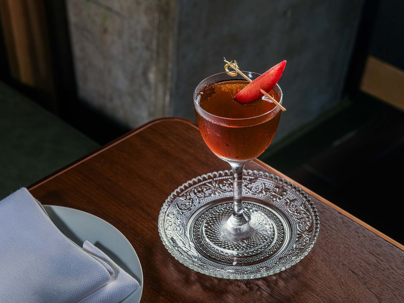 a glass of wine sitting on top of a wooden table