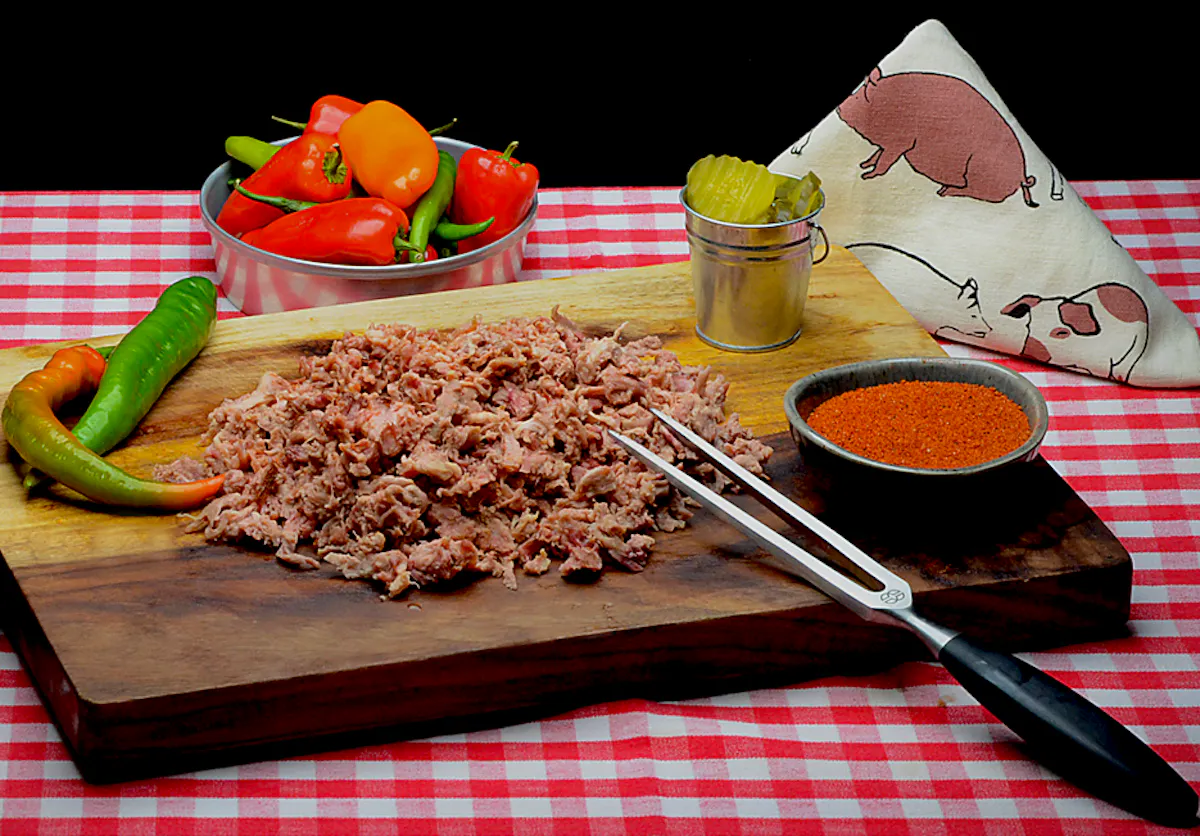 raw salmagundi with red sauce and pickles on the side
