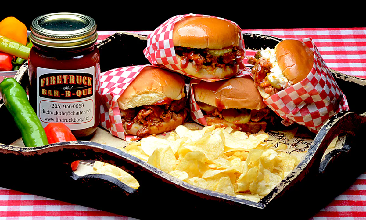 three pulled pork hamburgers served with chips