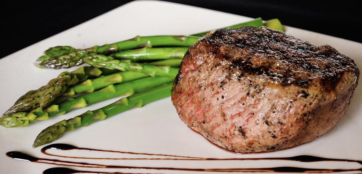 steak served with asparagus