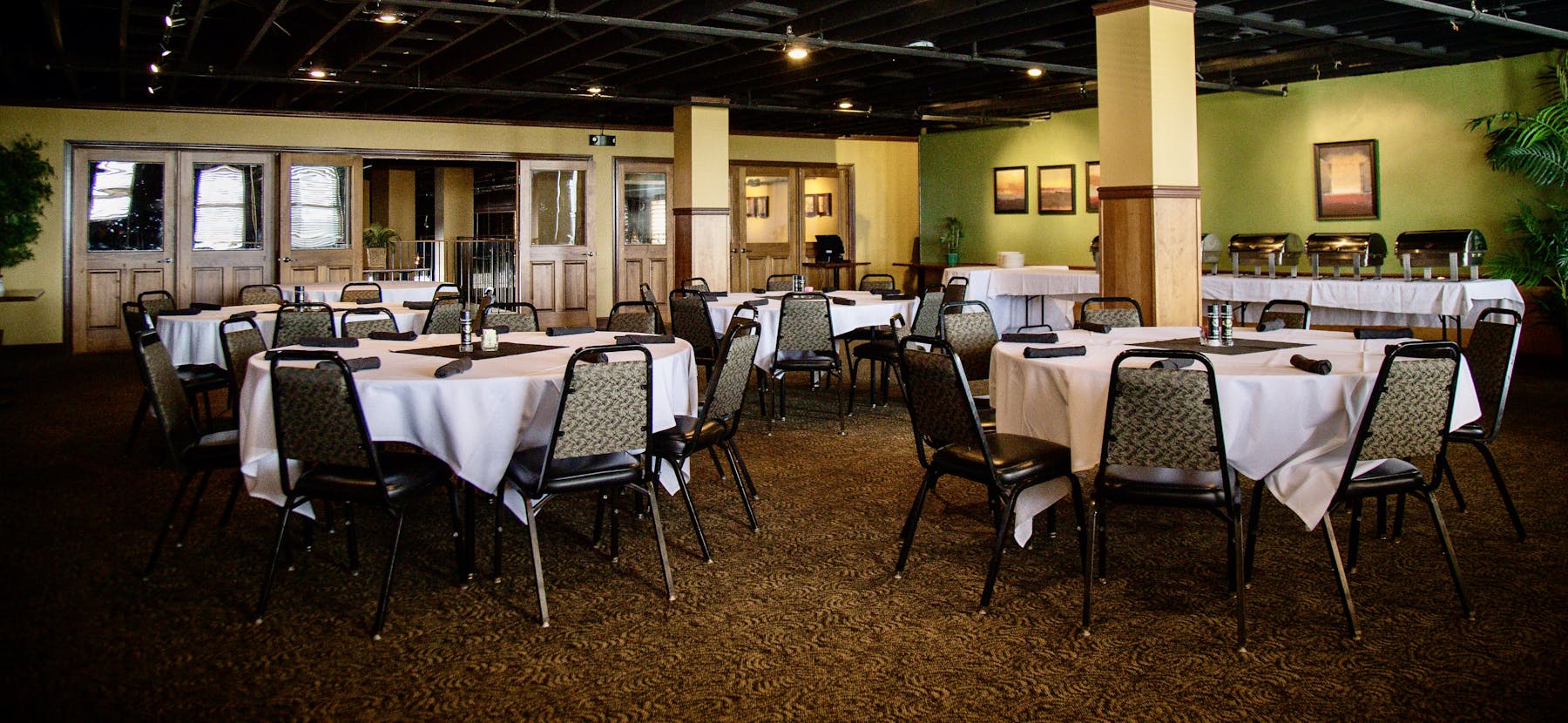 dining room tables on a restaurant room with buffet served on a table