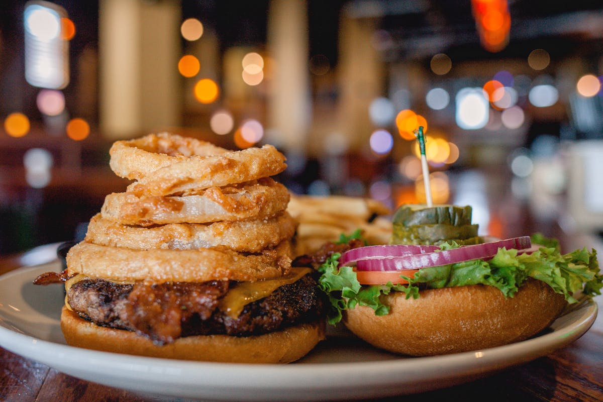a burger with onion rings 