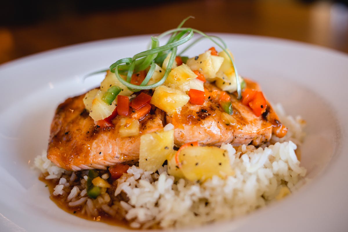 salmon served over a pile of rice