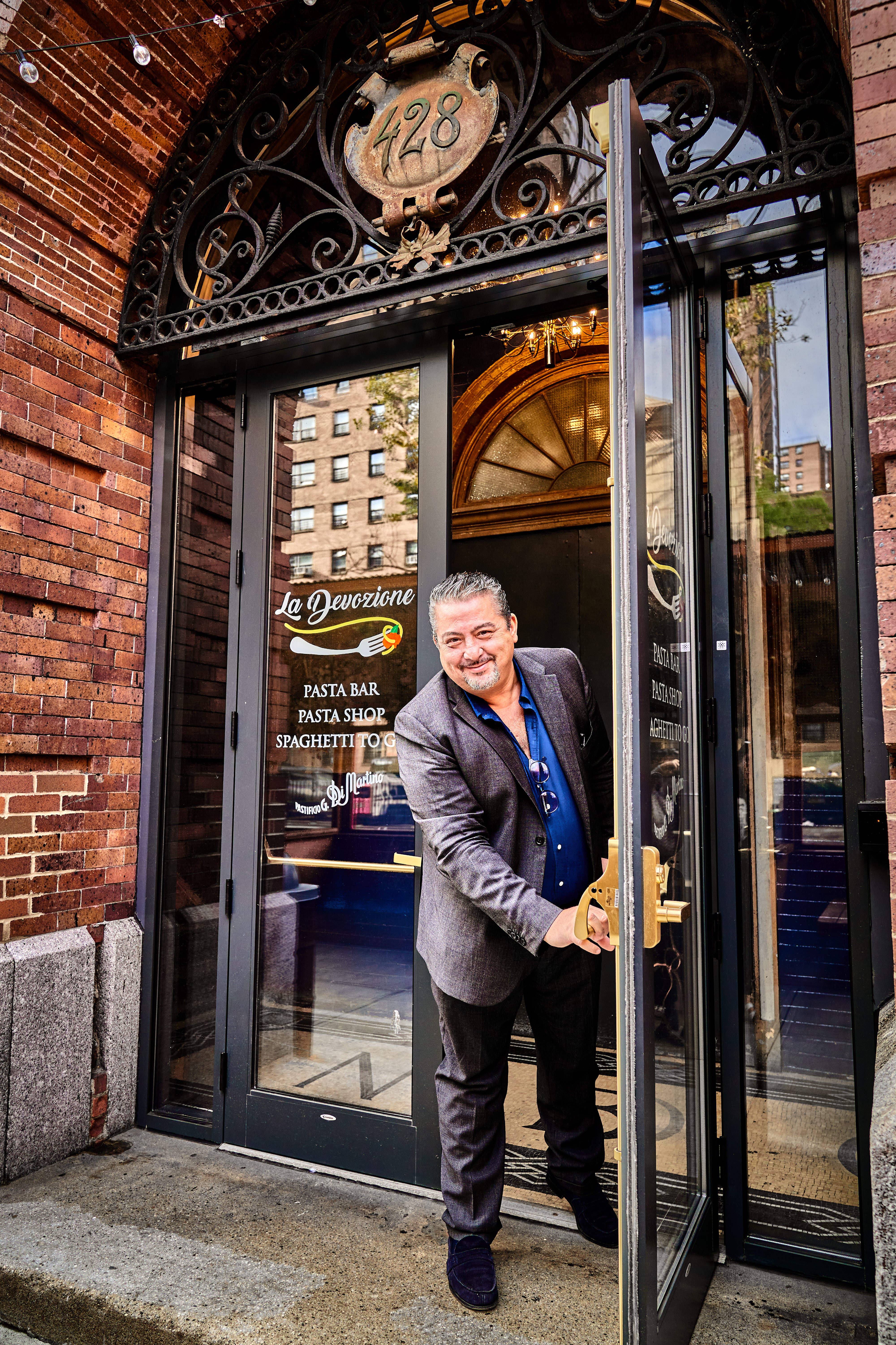 Giuseppe Di Martino standing in front of a building