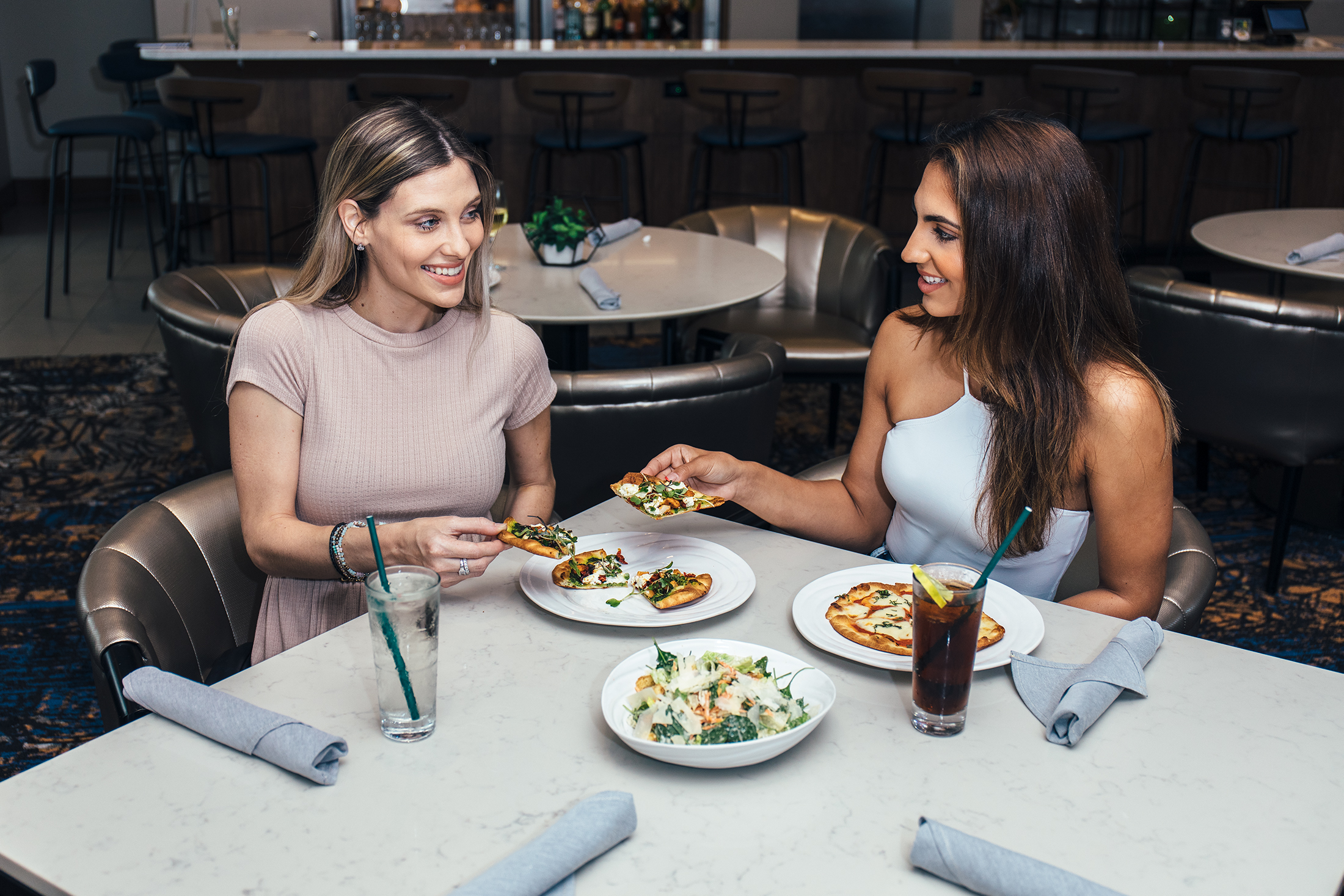 a person sitting at a table with a plate of food