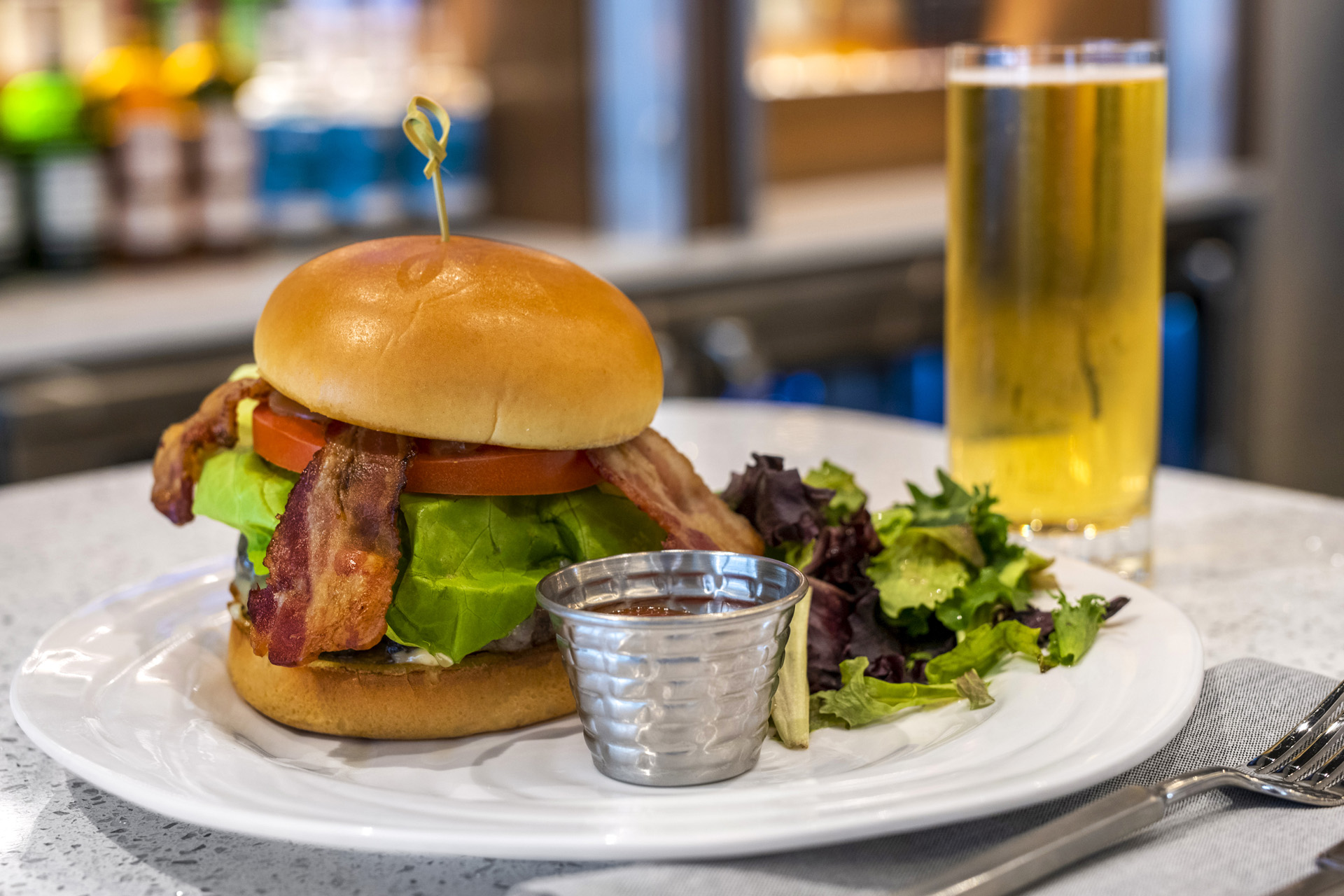 a sandwich sitting on top of a plate of food on a table