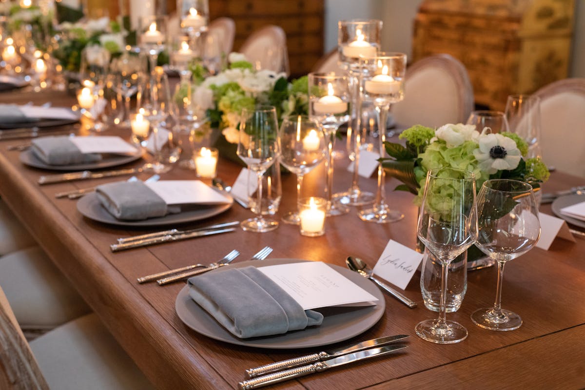 a group of people sitting at a table with wine glasses