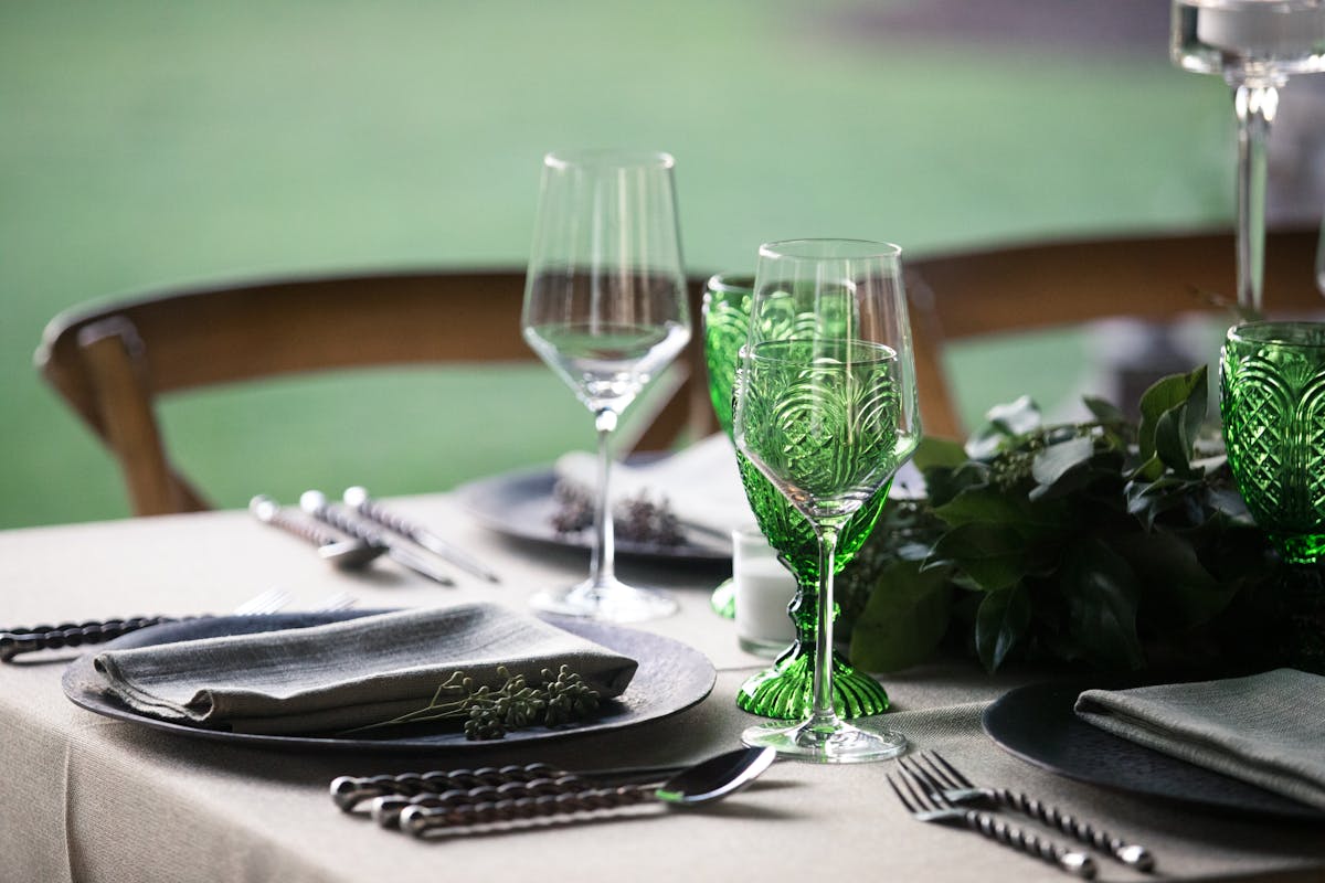 a table topped with glasses of wine