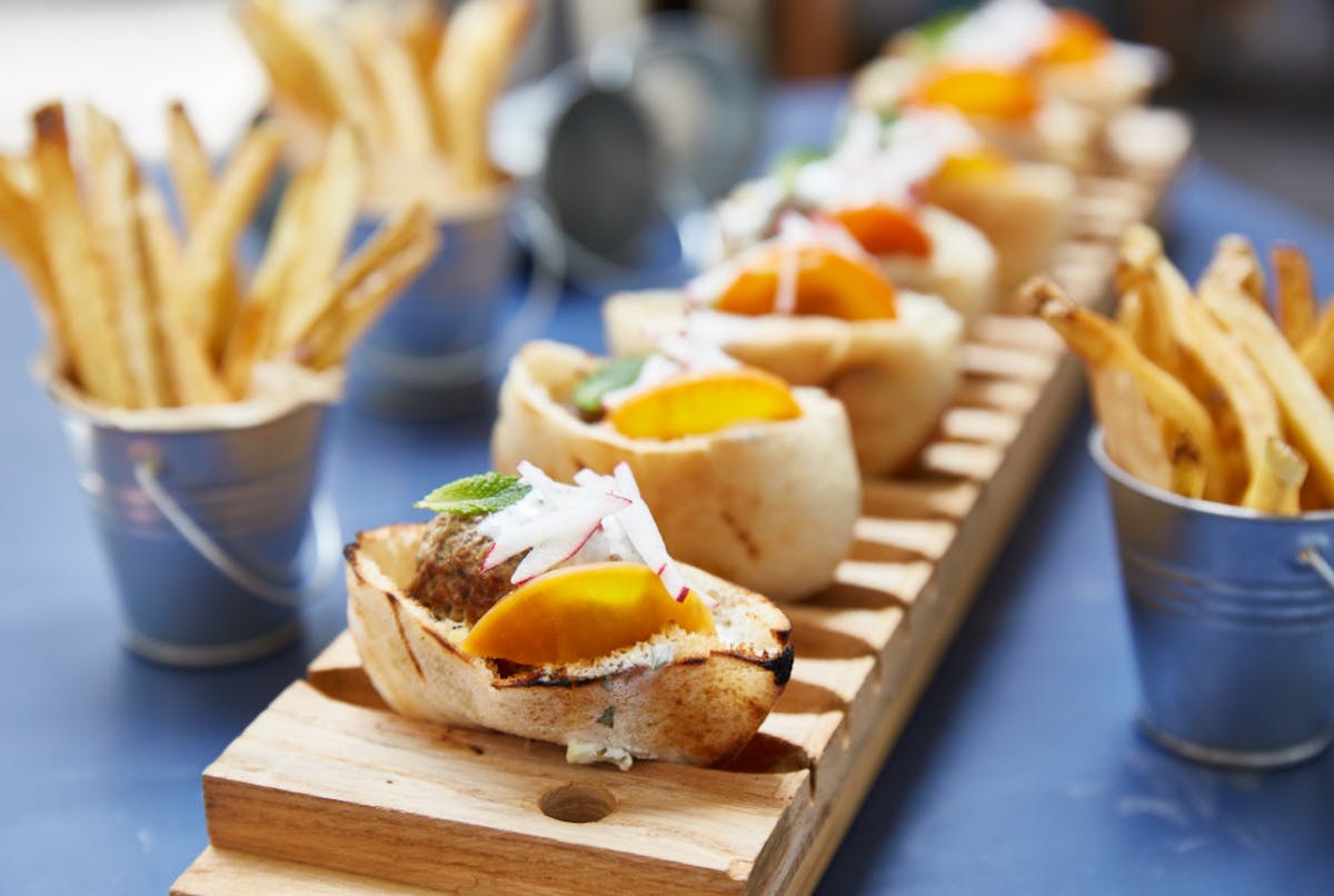 a banana sitting on top of a wooden table topped with plates of food