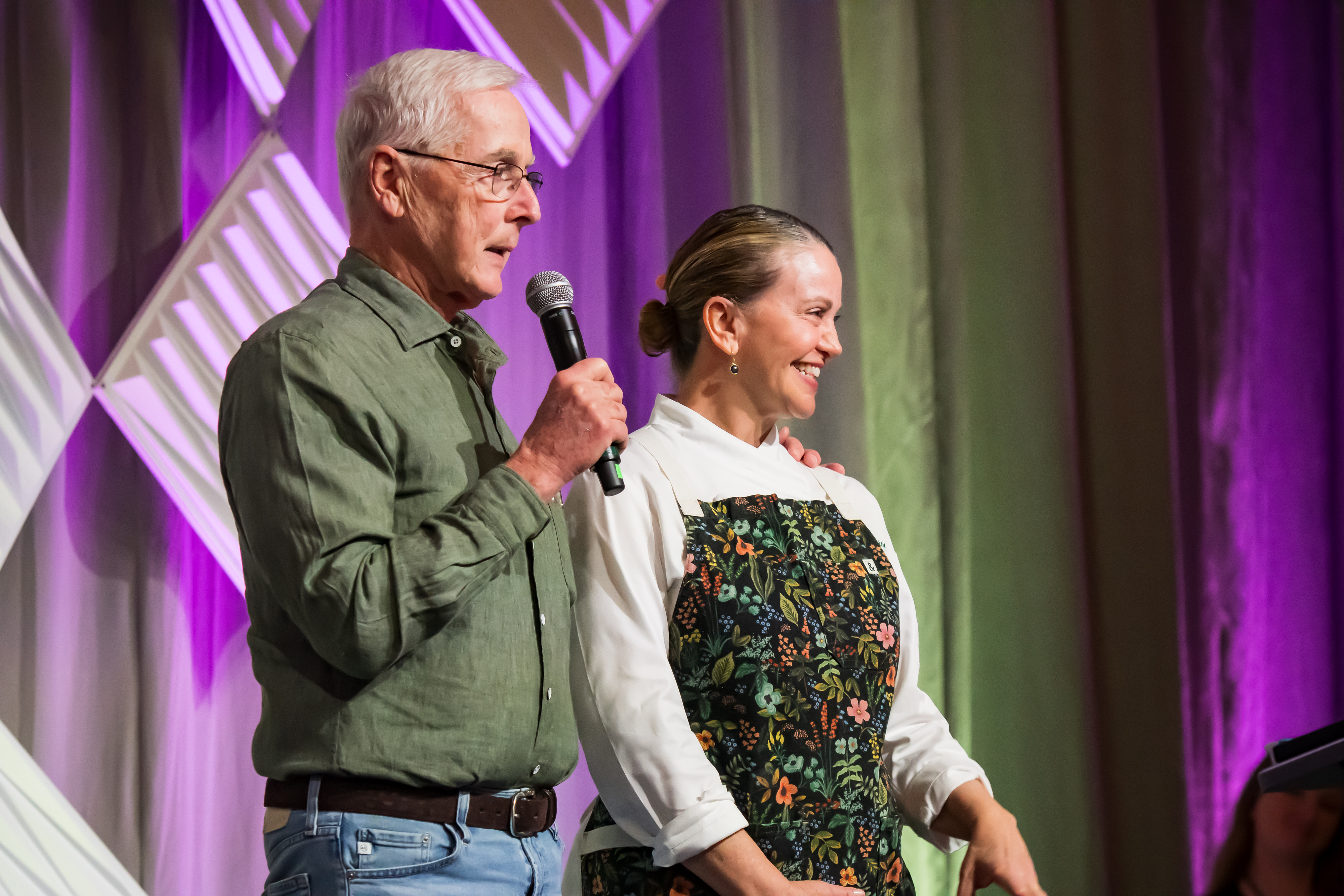 a man and woman standing on a stage