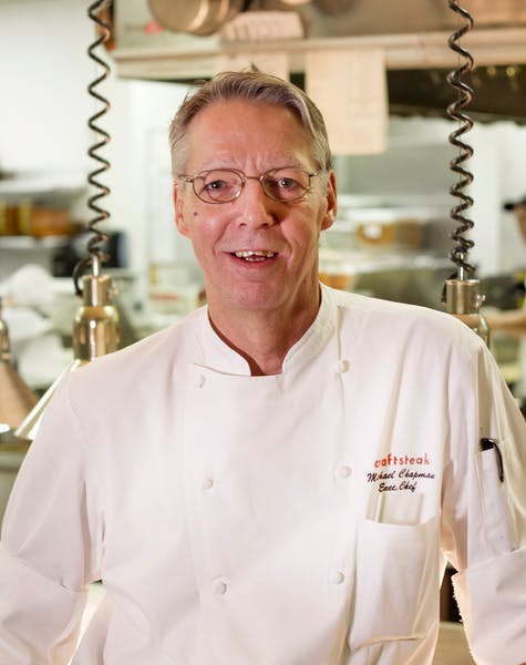 Christopher Hampton wearing glasses and smiling at the camera