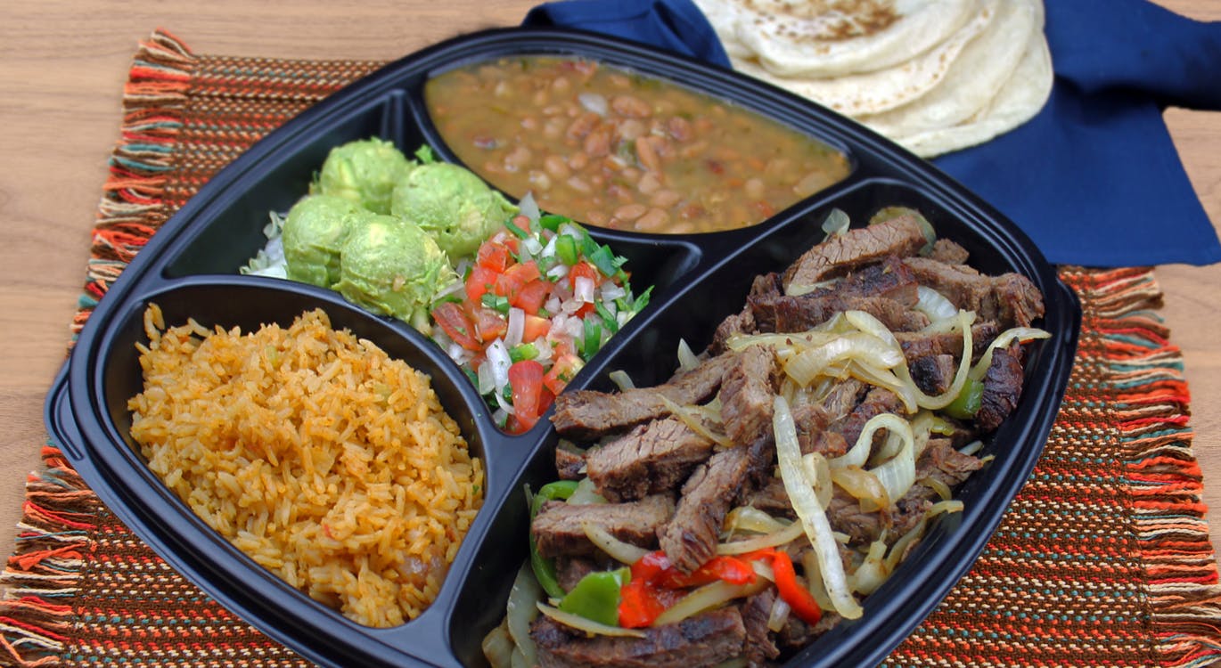 a plate of food with rice meat and vegetables