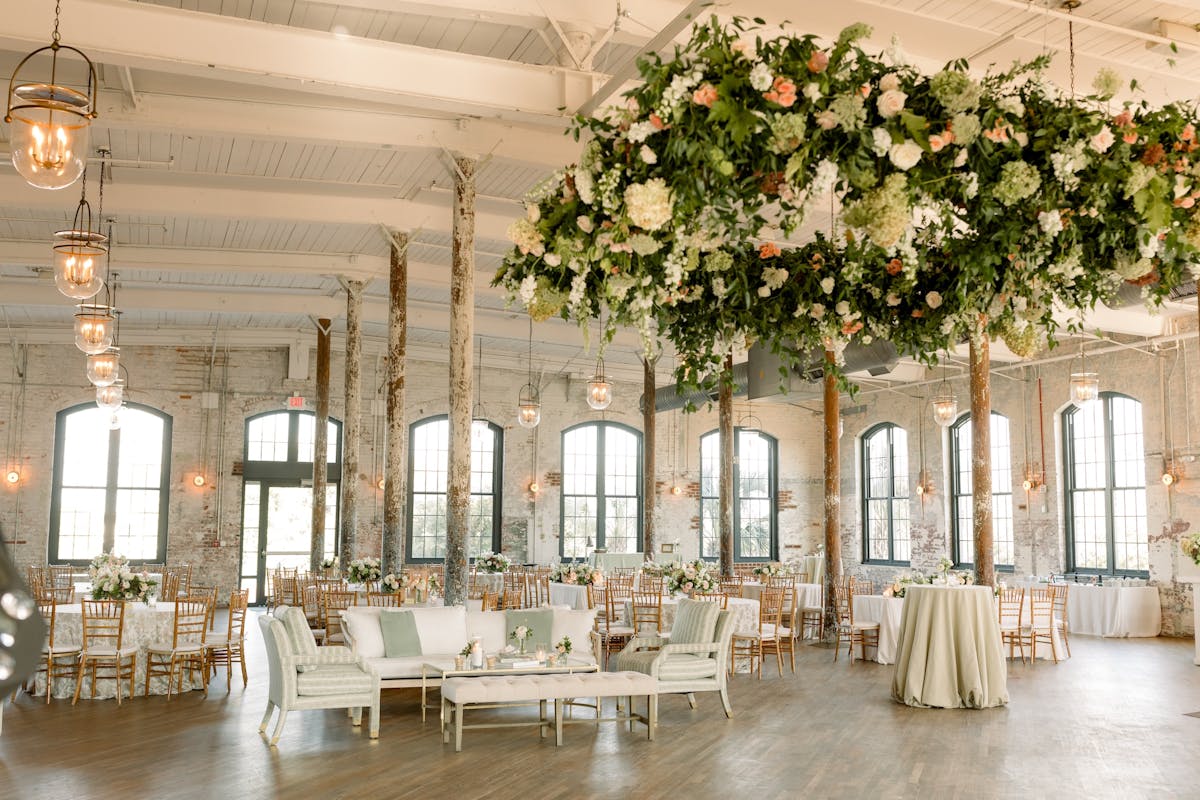 a room filled with furniture and vase of flowers on a table
