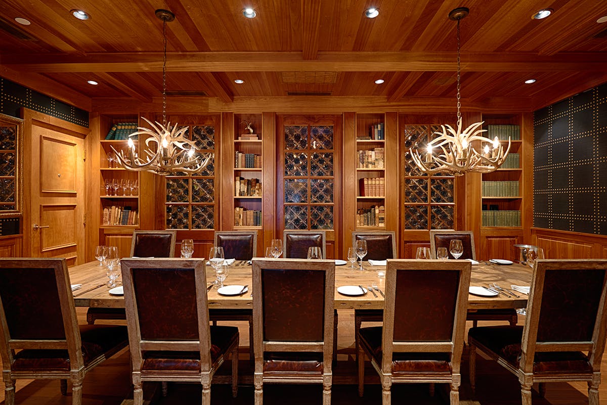 a large dining table topped with utensils