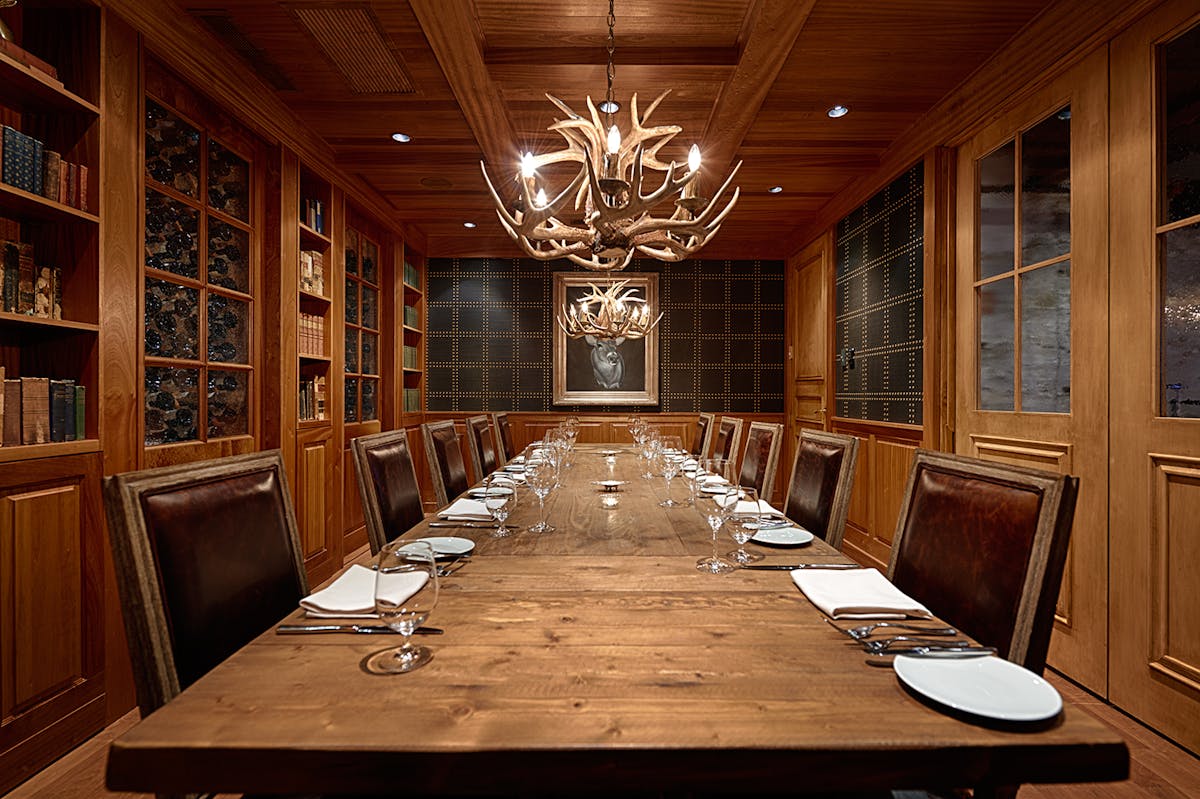 a large dining table topped with utensils