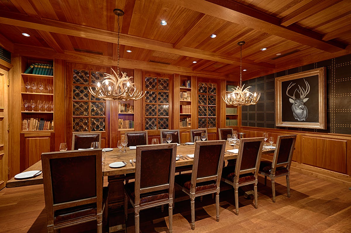 a large dining table topped with utensils