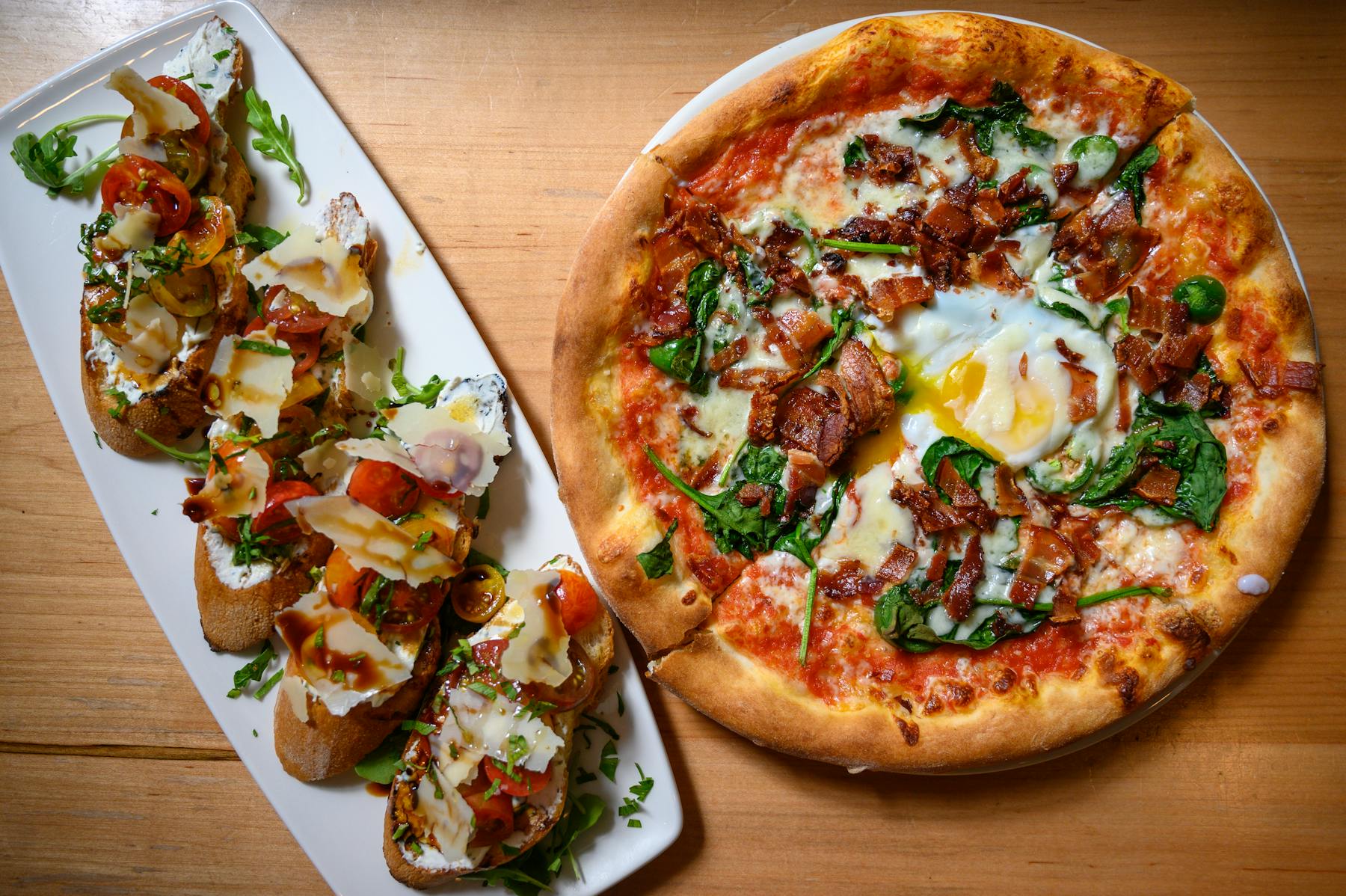 a pizza sitting on top of a wooden cutting board
