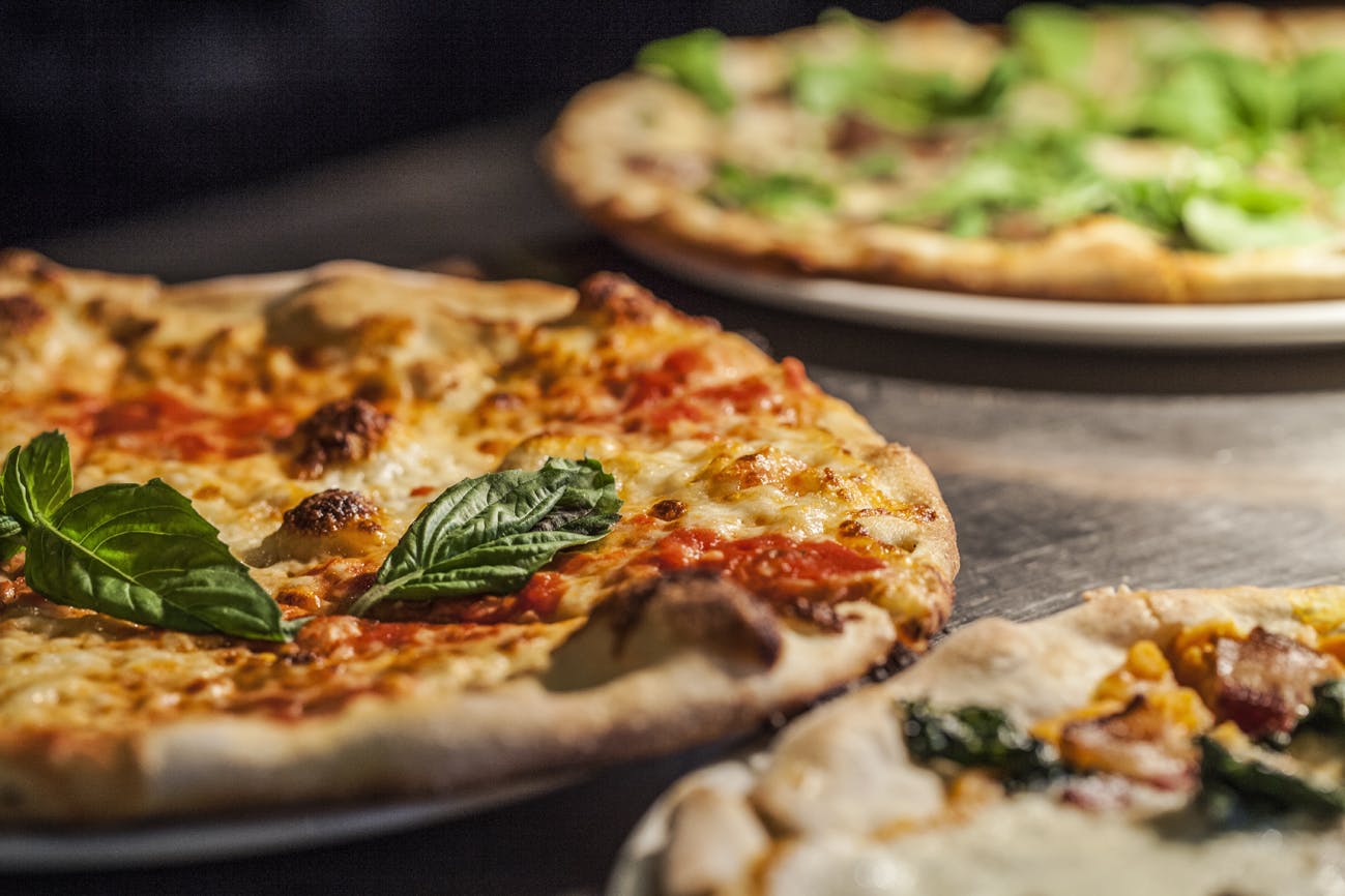 some pizzas sitting on a table