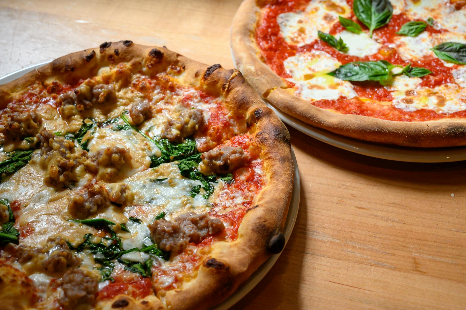 a pizza sitting on top of a wooden table