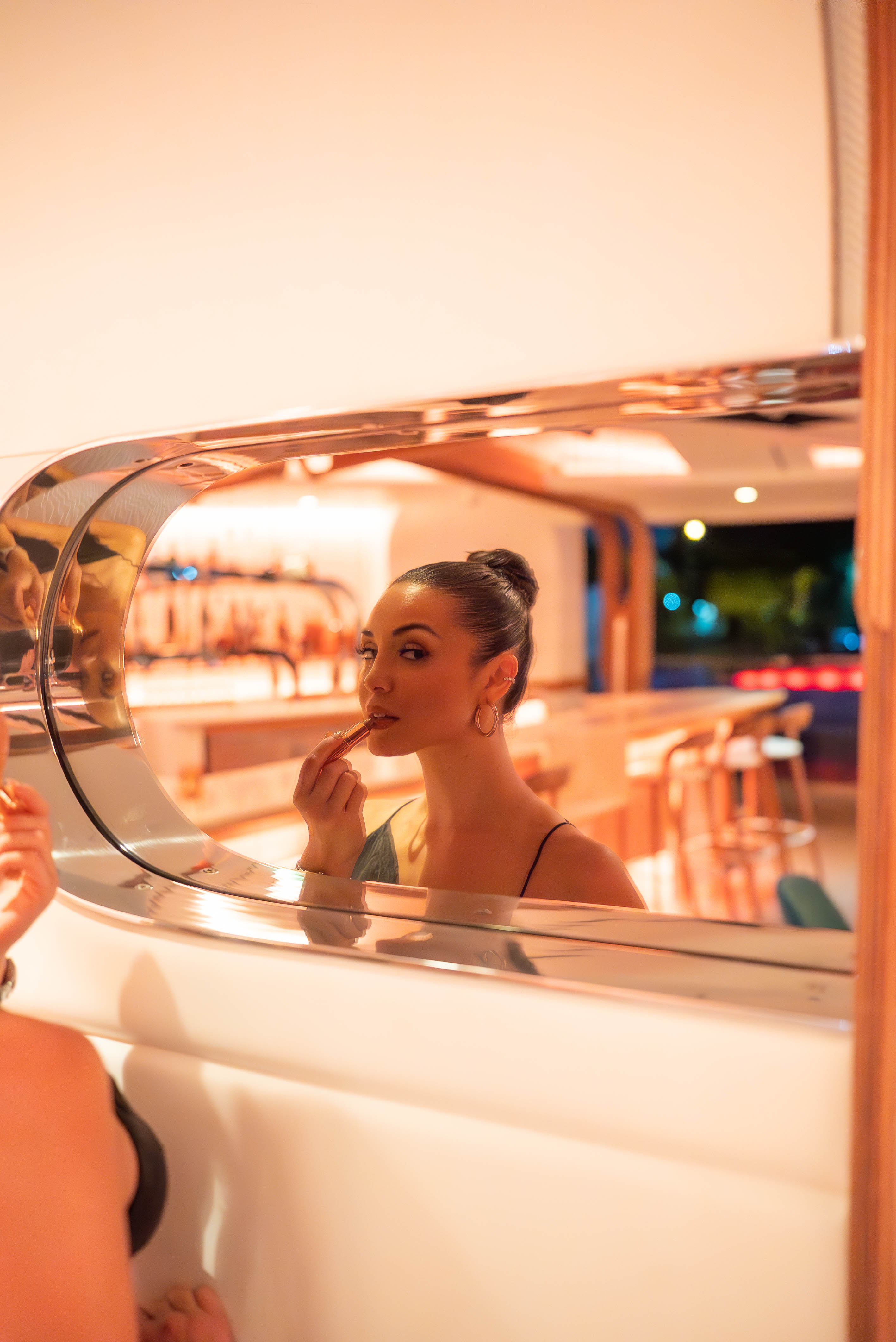 a person sitting in front of a mirror posing for the camera