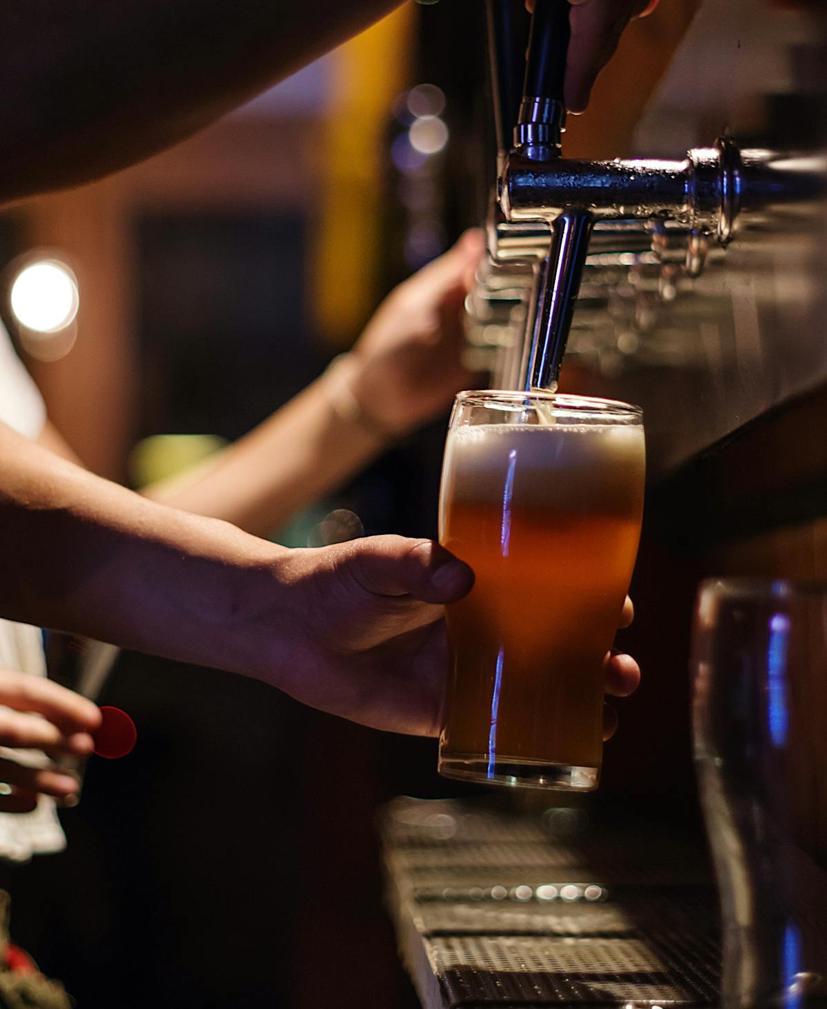 a person holding a beer glass