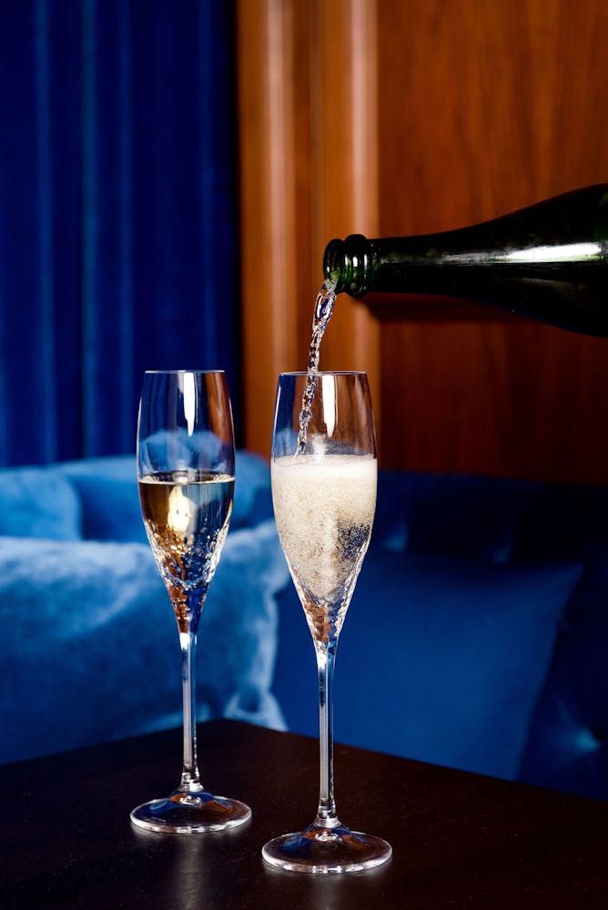 a glass of wine sitting on top of a table