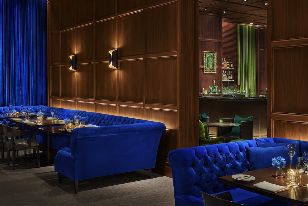 a room filled with furniture and a blue curtain