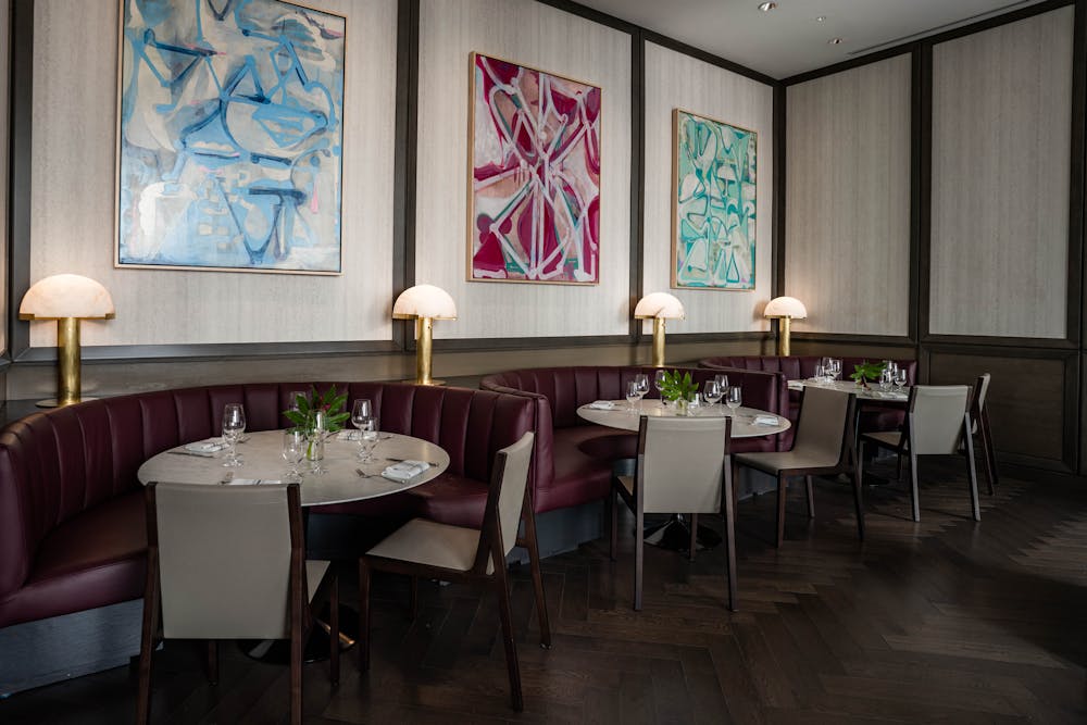 a living room filled with furniture and vase of flowers on a table