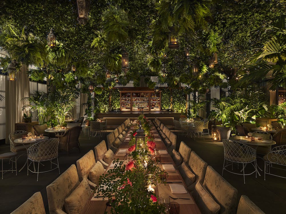 a room filled with furniture and vase of flowers on a table
