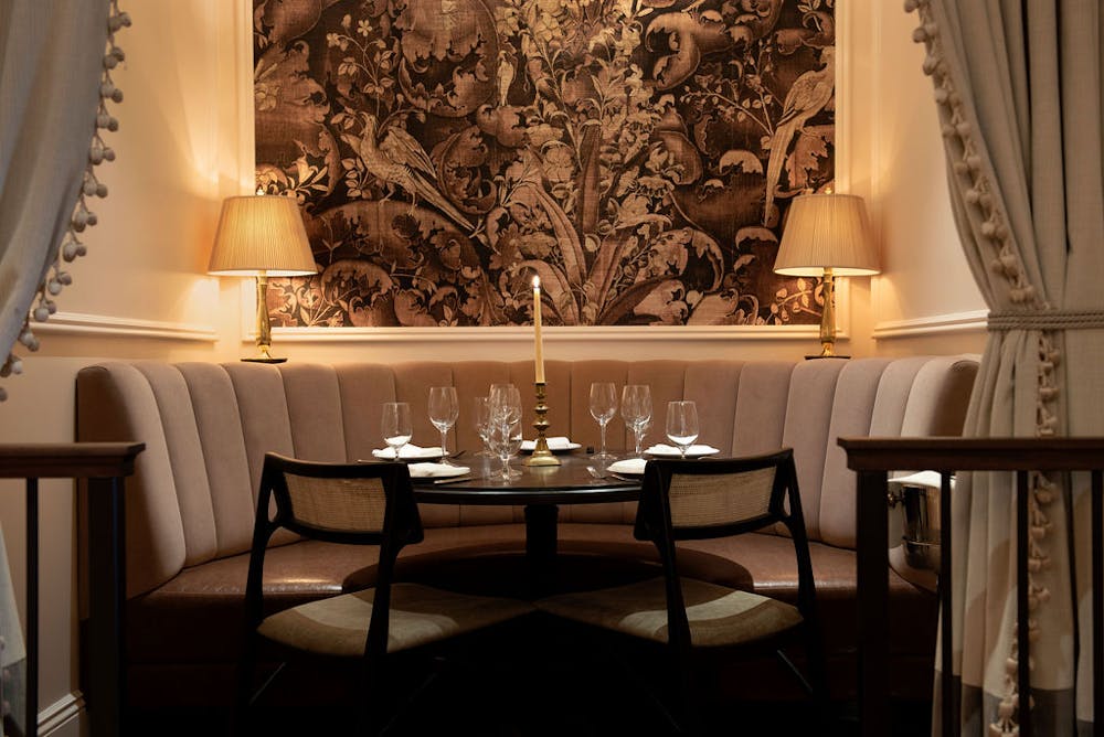 a room filled with furniture and a blue curtain